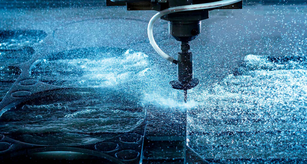 Abrasive waterjet cold cutting machine cutting steel plate at an industrial site in UAE