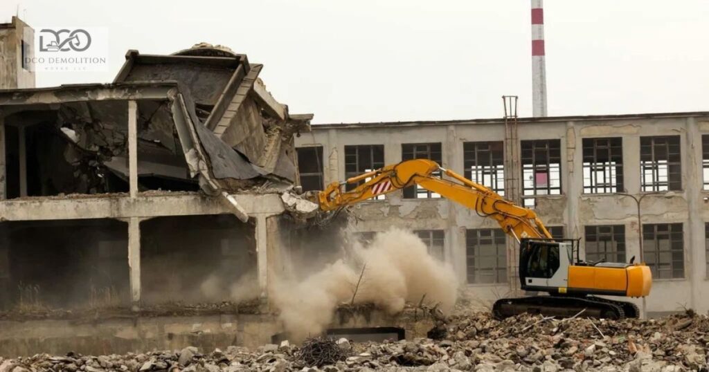 Industrial warehouse demolition in Dubai with excavator removing steel structure and concrete debris